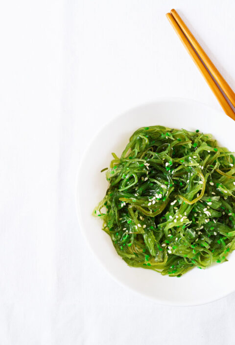 wakame chuka seaweed salad with sesame seeds bowl white table traditional japanese food top view flat lay scaled 1 | Ăn Chay, Thuần Chay, Quán Chay & Nhà Hàng Chay